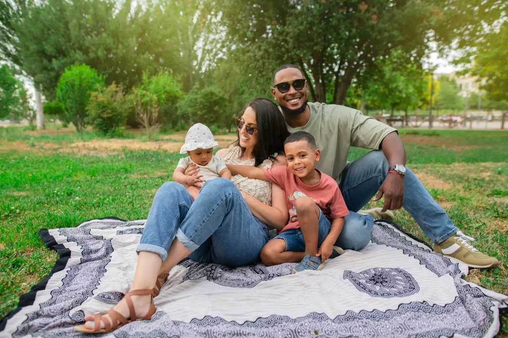 Happy family spanish-latin with their children in the park